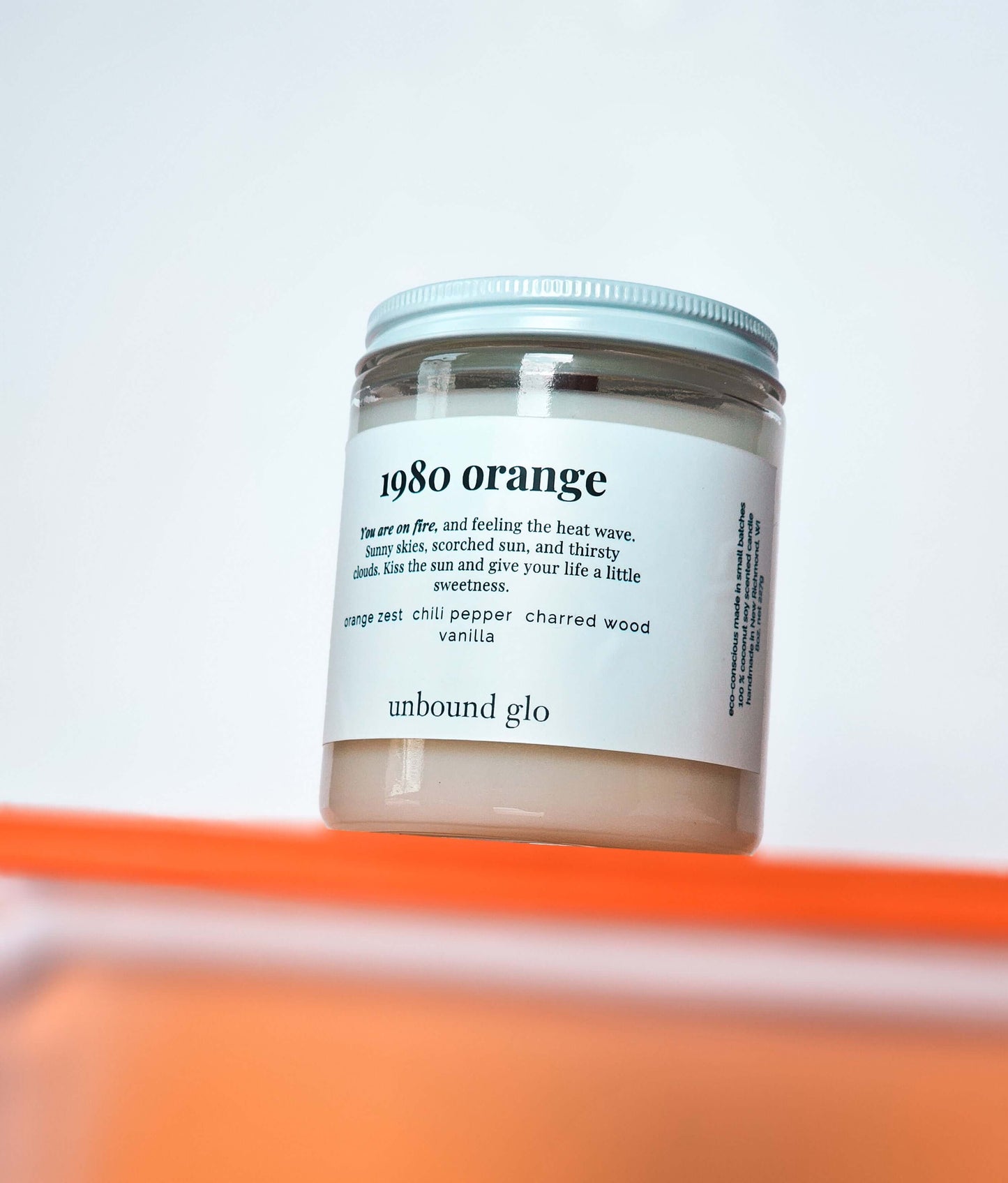 Candle, wooden wick, 1980 orange on front, notes of sweet orange, chili pepper, charred wood, vanilla